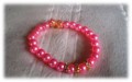 Yndig armbnd med lyserde perler med forgyldte mellemled (Fs ogs med forslvet mellemled)
