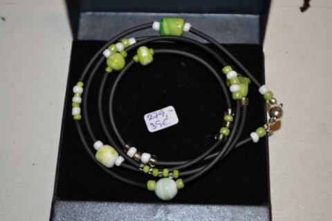 Bracelet with glassbeads in lime colours on rubber