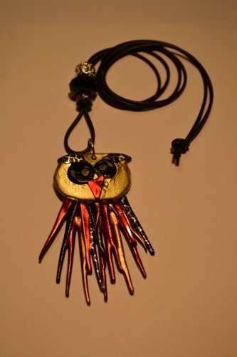 Necklace with an owl in gold and orange/red colours