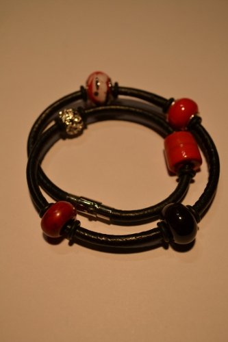 Leather bracelet with beads and charms in red