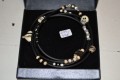Bracelet with glassbeads in black/white on a rubberchain
