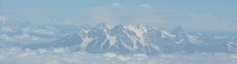 Alperne der stikker op gennem skyerne